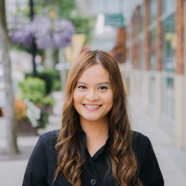 Dental staff member smiling on street