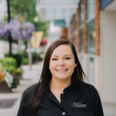 Dental staff member smiling on street