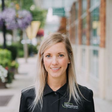 Dental hygienist Erin portrait smiling on street