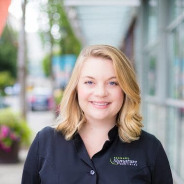 Dental hygienist Kelsey smiles outside Redmond Signature Dentistry
