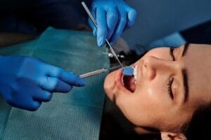 A woman getting her teeth cleaned by a Redmond sedation dentist.